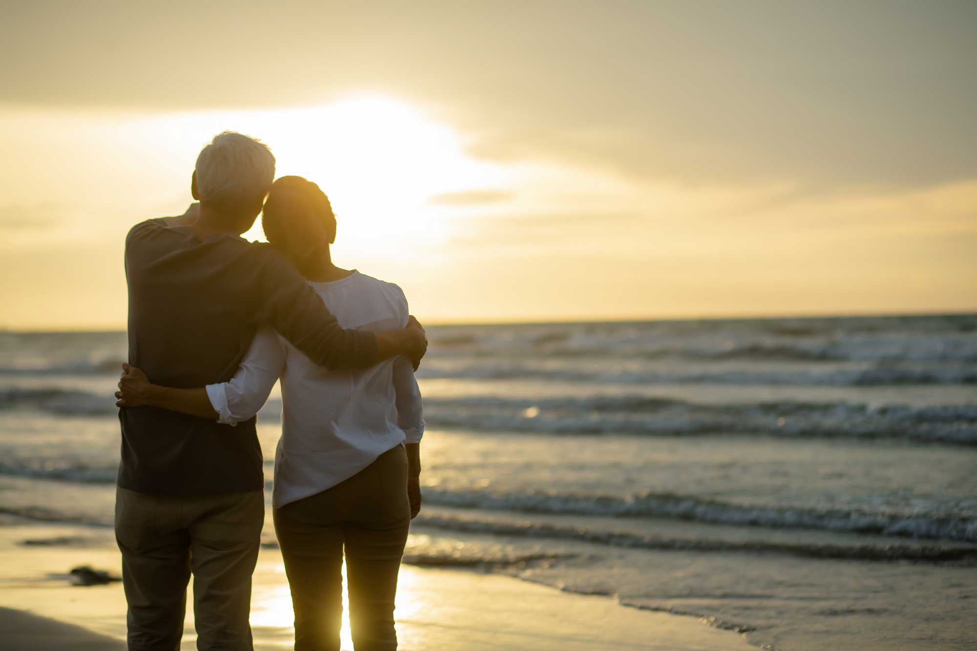 retired couple watches sunset